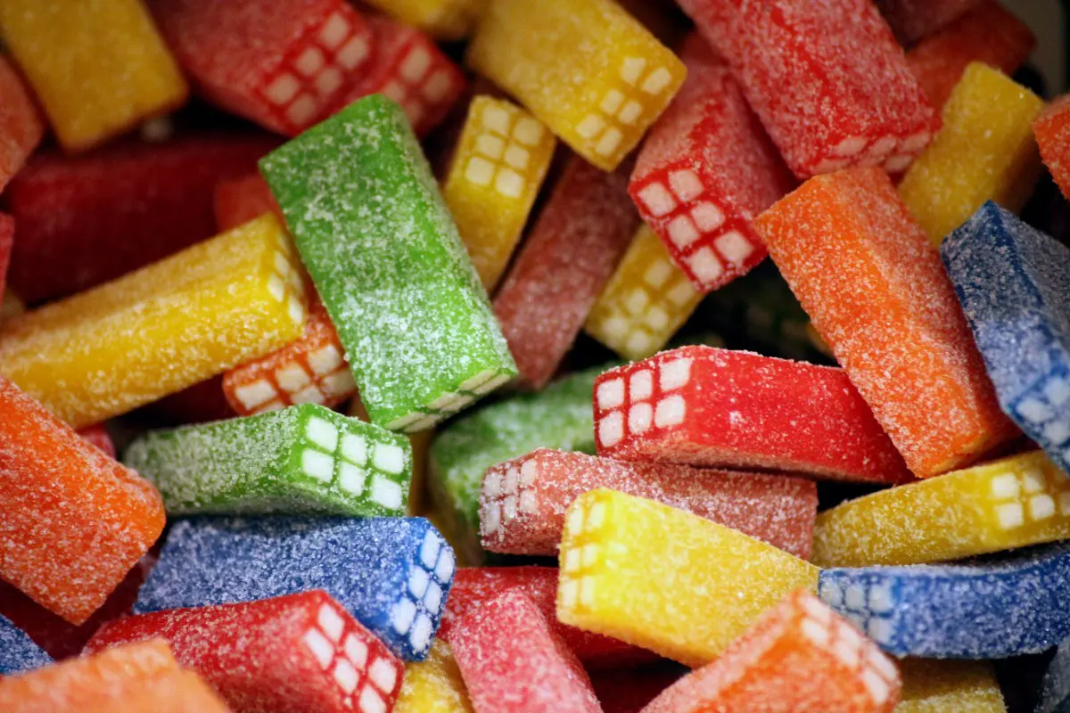 GettyImages-2148859221 A colorful assortment of sugar-coated chewy candies, shaped like rectangular blocks with a grid pattern on the sides, in red, yellow, green, orange, and blue.