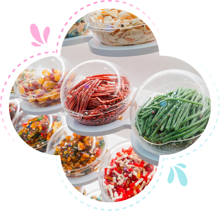 Group 1321317513 Display of various colorful candies in transparent spherical containers on a curved stand.